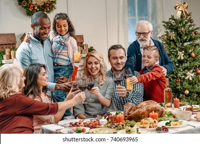 Large Family Clinking Glasses On Christmas Dinner