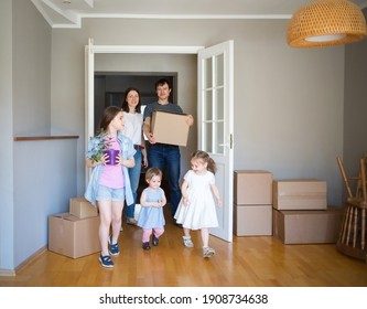 large family enters its new home. moving to apartment. boxes in house