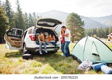 Large family of four kids. Children in trunk. Traveling by car in the mountains, atmosphere concept. American spirit. - Powered by Shutterstock