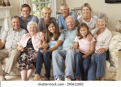 Large Family Group Sitting On Sofa Indoors