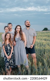 A Large Family Meets The Sunset In The Fresh Air. Photo For A Family Album At Sunset. Beautiful Sunset View.