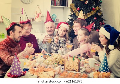 Large Family Members Enjoying Festive Meal During Christmas Dinner In Home Interior