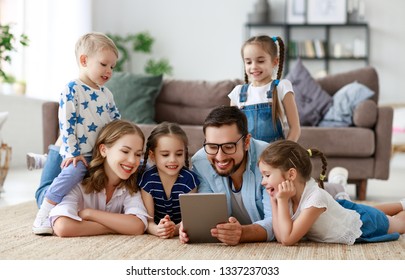 Large Family Mother, Father And Four Children With Tablet Computer At Home
