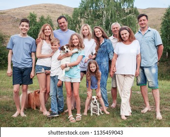 Large family outdoors. Mother, father, children, grandmother, grandfather and dog