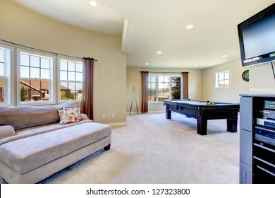 Large Family Room With Pool Table, Sofa  And Tv.