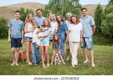 Large family vacationing in nature together. Several generations of the family - grandparents, parents, children and grandchildren spend their free time together - Powered by Shutterstock