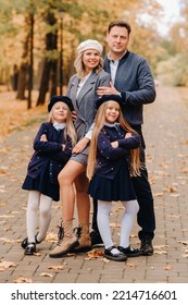 A Large Family Walks In The Park In The Fall. Happy People In The Autumn Park.