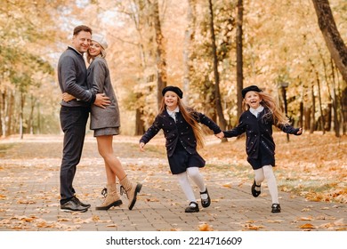 A Large Family Walks In The Park In The Fall. Happy People In The Autumn Park.