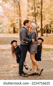 A Large Family Walks In The Park In The Fall. Happy People In The Autumn Park.