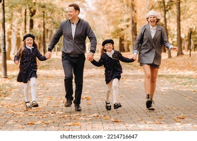 A Large Family Walks In The Park In The Fall. Happy People In The Autumn Park.