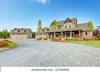 Large Farm Country House With Gravel Driveway And Green Landscape.