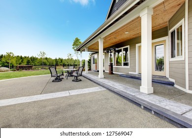 Large Farm Country House With Long Covered Porch And Terrace.