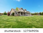 Large farm country house with spring green landscape, kids play ground.