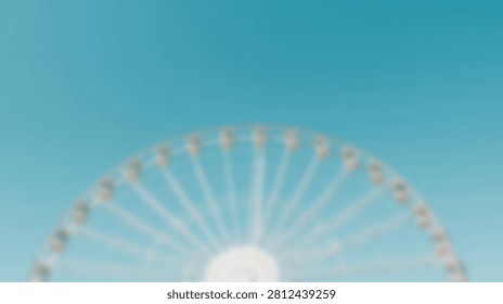 A large Ferris wheel is seen from below against a bright, cloudless blue sky. The structure is white and appears to be illuminated.
