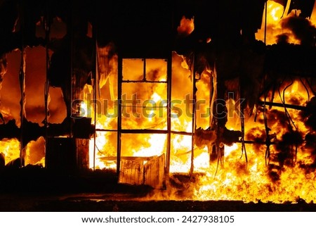 Large Fire Engulfing Building At Night