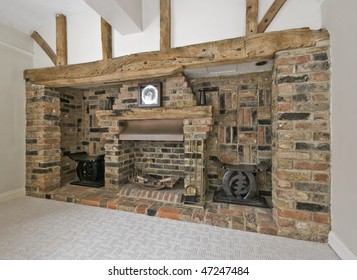 Large Fireplace With Exposed Brick And Hard Wood Construction