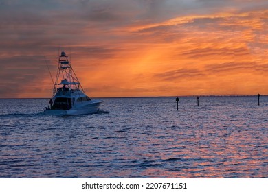 Large fishing troller heading out at sunset on the Gulf of Mexico in Destin, located in the Panhandle of Florida. - Shutterstock ID 2207671151
