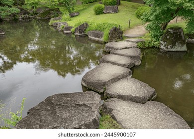 Large flat rocks forming a path over a Japanese pond.
Koko-en zen garden near Himeji castle.