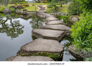 Large flat rocks forming a path over a Japanese pond.
Koko-en zen garden near Himeji castle. - Powered by Shutterstock