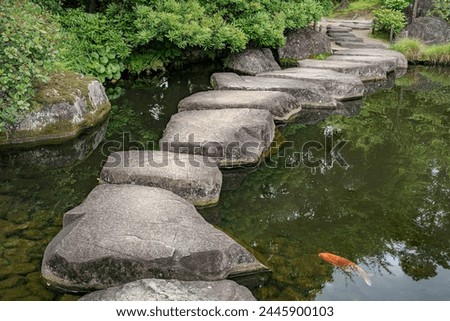 Large flat rocks forming a path over a Japanese pond.
Koko-en zen garden near Himeji castle.