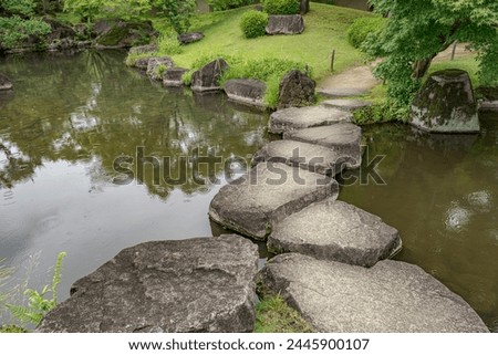 Large flat rocks forming a path over a Japanese pond.
Koko-en zen garden near Himeji castle.