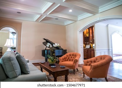 Large Formal Living Room In A Spacious Home. Arched Doorway Entrance And Comfortable Furniture With A Baby Grand Piano. Coffered Ceiling And A Lot Of Natural Light From The Large Windows.