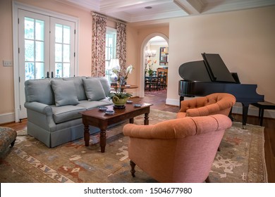 Large Formal Living Room In A Spacious Home. Arched Doorway Entrance And Comfortable Furniture With A Baby Grand Piano. Coffered Ceiling And A Lot Of Natural Light From The Large Windows.