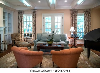 Large Formal Living Room In A Spacious Home. Arched Doorway Entrance And Comfortable Furniture With A Baby Grand Piano. Coffered Ceiling And A Lot Of Natural Light From The Large Windows.