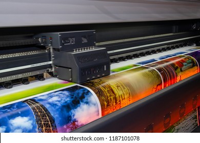 Large format printing machine in operation. Industry - Shutterstock ID 1187101078