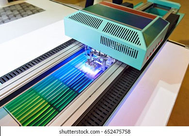 Large format UV coating printer in work