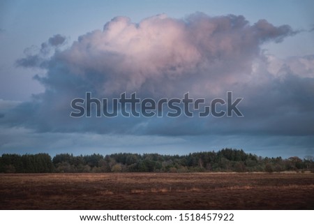 Large formidable cloud over the countryside at sunset. West Lothian, Scotland
