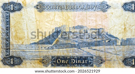 Large fragment of reverse side of 1 one Libyan dinar banknote currency issued 1972 by the central bank of Libya with Sabha fortress castle image at the center, vintage retro, old Libyan money banknote