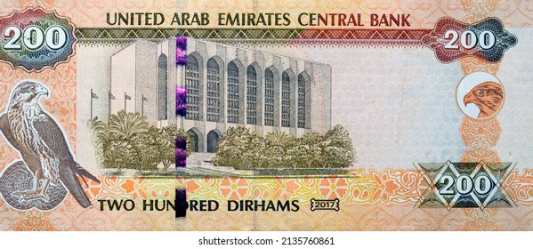 Large fragment of reverse side of 200 AED two hundred Dirhams banknote of United Arab Emirates that features the imagery of the Central Bank of the UAE and a falcon image, Emirates money banknote - Shutterstock ID 2135760861