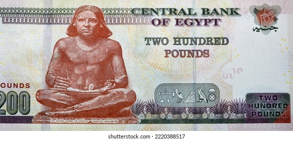 Large fragment of the reverse side of 200 LE EGP two hundred Egyptian pounds cash money banknote paper series 2022 features the seated scribe of ancient Egypt, selective focus of Egyptian money - Shutterstock ID 2220388517