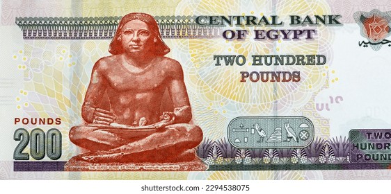 Large fragment of the reverse side of 200 LE EGP two hundred Egyptian pounds cash money banknote paper series 2022 features the seated scribe of ancient Egypt, selective focus of Egyptian money