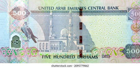 Large fragment of reverse side of 500 AED five hundred Dirhams banknote of United Arab Emirates money, currency of the UAE with picture of a falcon and Jumeirah mosque, selective focus