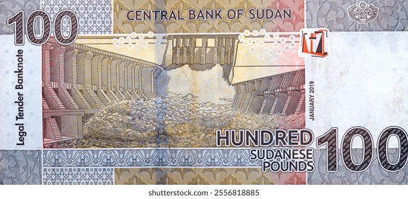 Large fragment of reverse side of one hundred Sudanese pounds issued by central bank of Sudan 2019, features Merowe hydroelectric dam river Nile that opened in 2009, Sudan money banknote