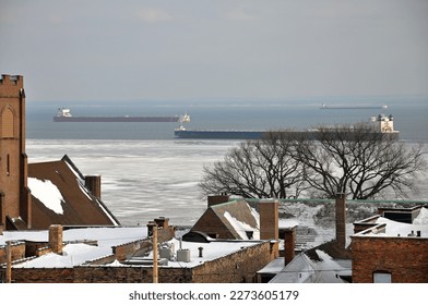 Large freighters (lakers) carry iron ore, coal, grain, lumber and more on the Great Lakes shown near the Port of Duluth-Superior from the city's hillside neighborhood