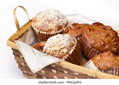 Large fresh muffins in a cane basket