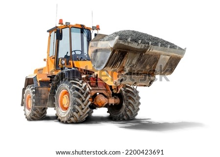 A large front loader transports crushed stone or gravel in a bucket at a construction site. Transportation of bulk materials. Isolated loader on a white background