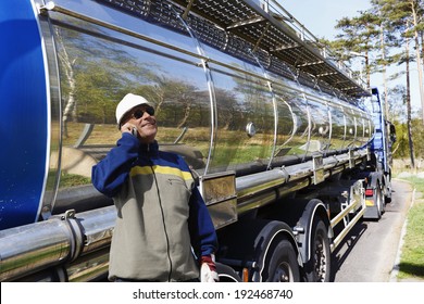 Large Fuel And Oil Truck With Driver Talking In Phone After Re-fueling.