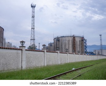 Large Fuel Tanks. Tanks And Ladders Of The Tank Farm. The Gloomy Atmosphere Of An Industrial Area. Oil Storage
