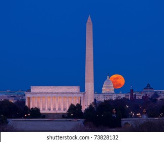 Large full moon rises through the haze over the Capitol building in Washington DC with Lincoln Memorial and Washington Monument aligned - Powered by Shutterstock