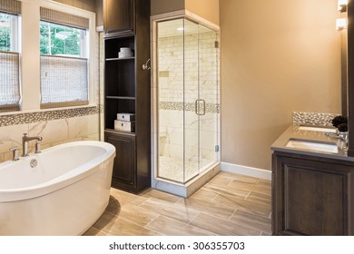 Large Furnished Bathroom In Luxury Home With Tile Floor, Fancy Cabinets, Large Mirror, Shower, And Bathtub