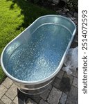 Large galvanized tub filled with ice water for ice bath