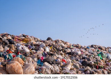 large garbage pile, global warming on sky background