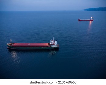 Large general cargo ship tanker bulk carrier, Top down aerial view at night.