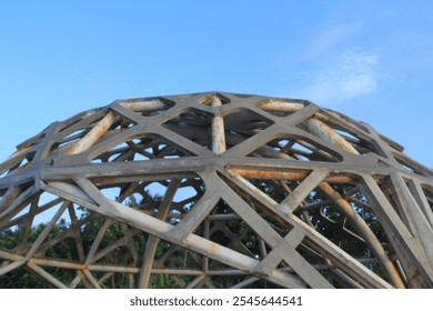 Large geodesic dome structure with intricate metal framework. Captured against a blue sky, this architectural design showcases modern construction and industrial style. Ideal for design, architecture, - Powered by Shutterstock