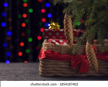 A Large Gift Basket Under A Christmas Tree On A Bokeh Background. Christmas And New Year Holidays.