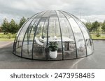A large glass dome with a table and chairs inside. Meeting room in the glass dome.